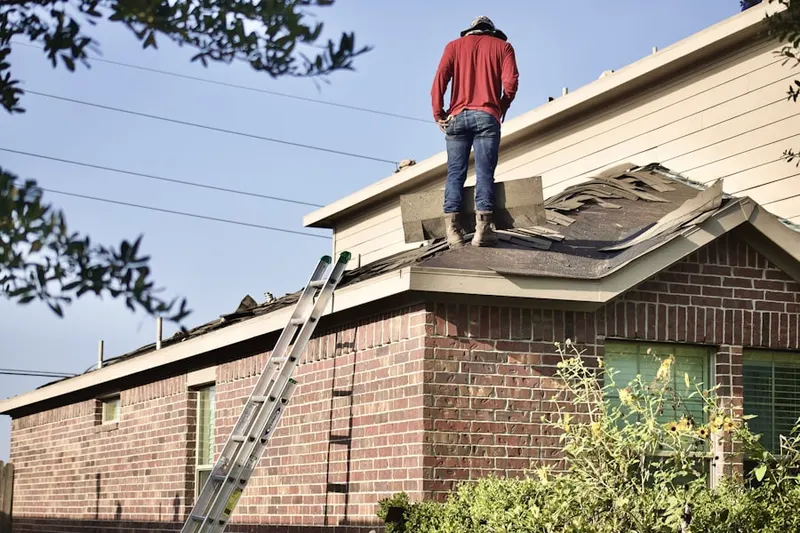 Professional roofer working on a residential roof in Waunakee